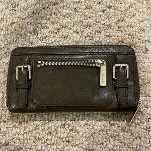 Michael Kors wallet with gold hardware and buckles